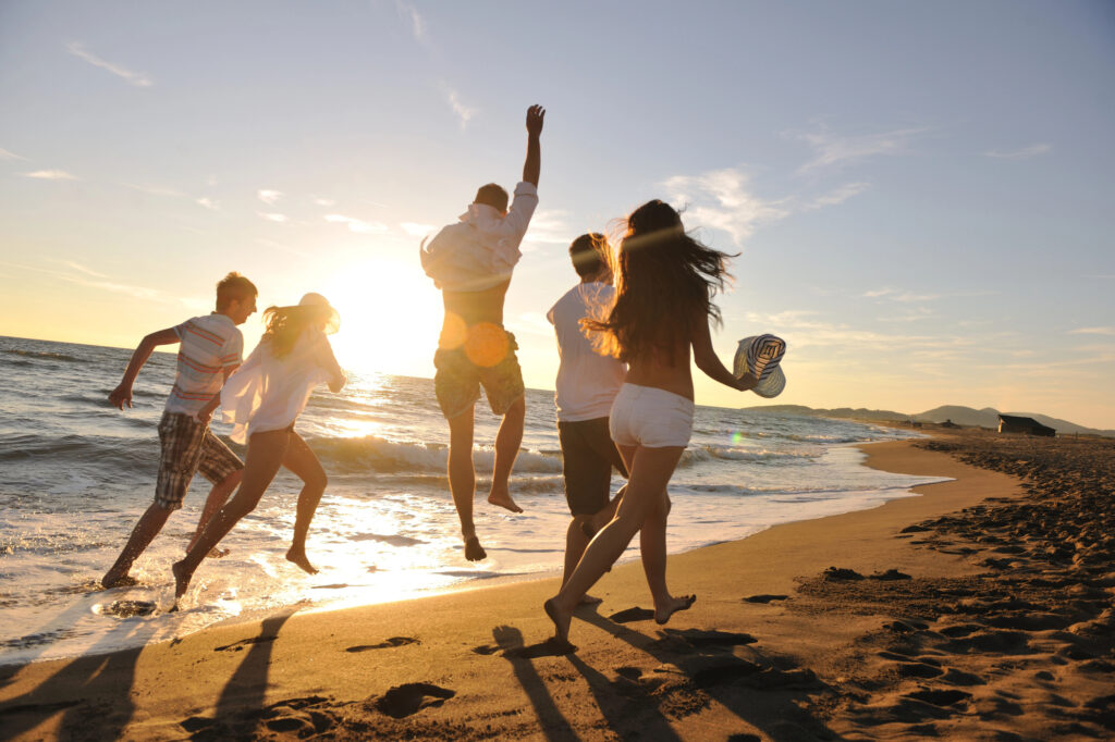 Group of people coming together at a beautiful beach